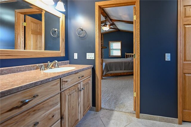 W5937 Ross Rd, Trego, WI 54888 - bathroom with lofted ceiling, connected bathroom, vanity, tile patterned floors, and ceiling fan
