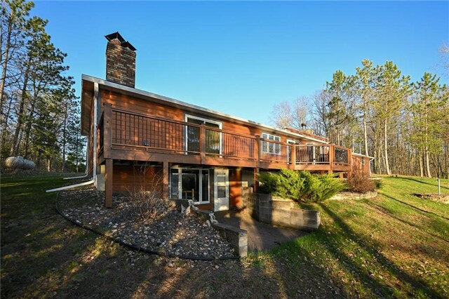 W5937 Ross Rd, Trego, WI 54888 - back of house with a lawn, a wooden deck, and a chimney