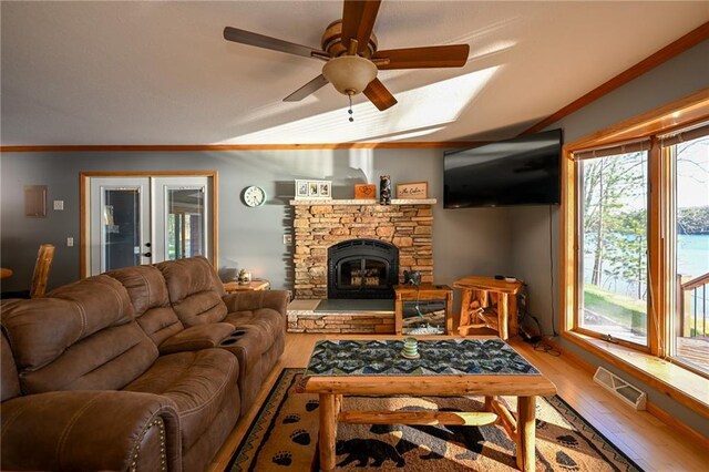 W5937 Ross Rd, Trego, WI 54888 - living area featuring wood finished floors, a ceiling fan, ornamental molding, and a stone fireplace