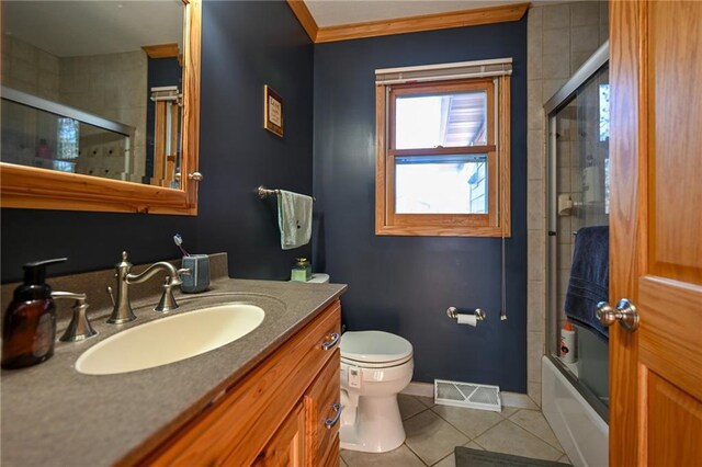 W5937 Ross Rd, Trego, WI 54888 - bathroom with tile patterned floors, vanity, baseboards, toilet, and enclosed tub / shower combo