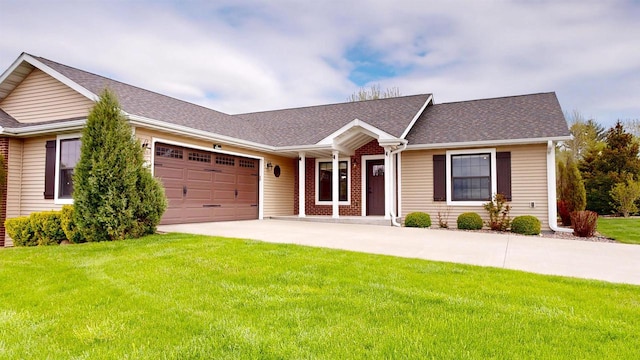 421 John Michael Dr, Jefferson, WI 53549 - ranch-style home featuring a garage, a front yard, driveway, a shingled roof, and covered porch