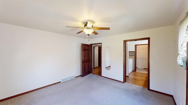 421 John Michael Dr, Jefferson, WI 53549 - unfurnished bedroom featuring light carpet, baseboards, and a ceiling fan