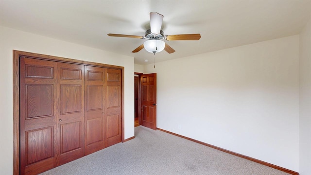 421 John Michael Dr, Jefferson, WI 53549 - unfurnished bedroom featuring light carpet, baseboards, a closet, and a ceiling fan