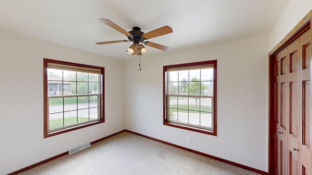 421 John Michael Dr, Jefferson, WI 53549 - empty room featuring healthy amount of natural light, baseboards, a ceiling fan, and light colored carpet