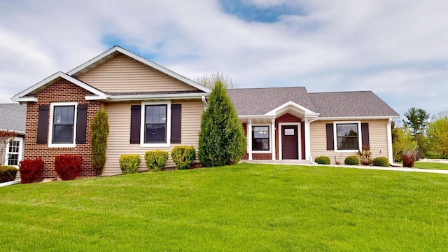 421 John Michael Dr, Jefferson, WI 53549 - single story home with a front lawn, brick siding, and a shingled roof