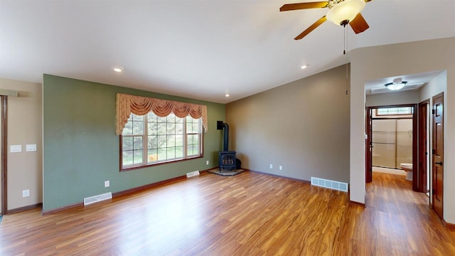 421 John Michael Dr, Jefferson, WI 53549 - unfurnished living room with a wood stove, healthy amount of natural light, light wood-type flooring, and recessed lighting
