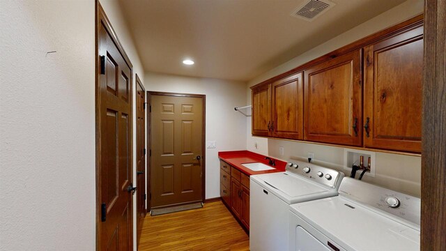 421 John Michael Dr, Jefferson, WI 53549 - washroom with washing machine and clothes dryer, cabinet space, light wood-style floors, and recessed lighting