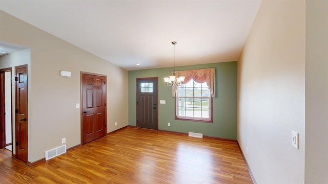 421 John Michael Dr, Jefferson, WI 53549 - entryway featuring a chandelier, light wood-type flooring, and baseboards
