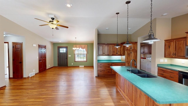421 John Michael Dr, Jefferson, WI 53549 - kitchen featuring separate washer and dryer, a sink, light wood-type flooring, lofted ceiling, and a large island with sink