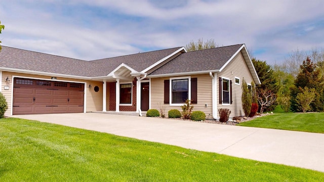421 John Michael Dr, Jefferson, WI 53549 - ranch-style house with concrete driveway, an attached garage, a front yard, and a shingled roof