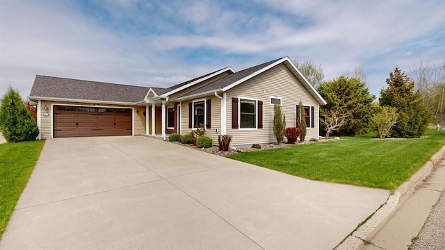 421 John Michael Dr, Jefferson, WI 53549 - ranch-style home with a garage, concrete driveway, a front lawn, and roof with shingles