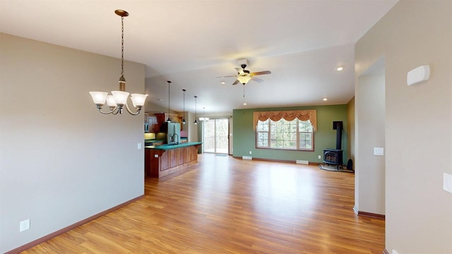 421 John Michael Dr, Jefferson, WI 53549 - kitchen featuring open floor plan, light wood finished floors, a breakfast bar, stainless steel fridge with ice dispenser, and a chandelier