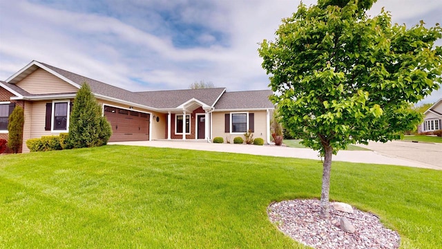421 John Michael Dr, Jefferson, WI 53549 - view of front of house featuring a garage, concrete driveway, and a front lawn