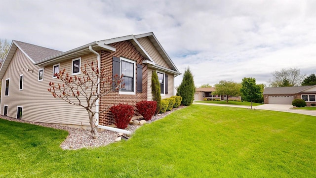 421 John Michael Dr, Jefferson, WI 53549 - view of home's exterior featuring brick siding and a yard