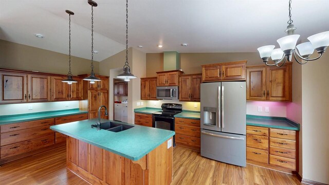 421 John Michael Dr, Jefferson, WI 53549 - kitchen with appliances with stainless steel finishes, a sink, brown cabinetry, vaulted ceiling, and light wood finished floors