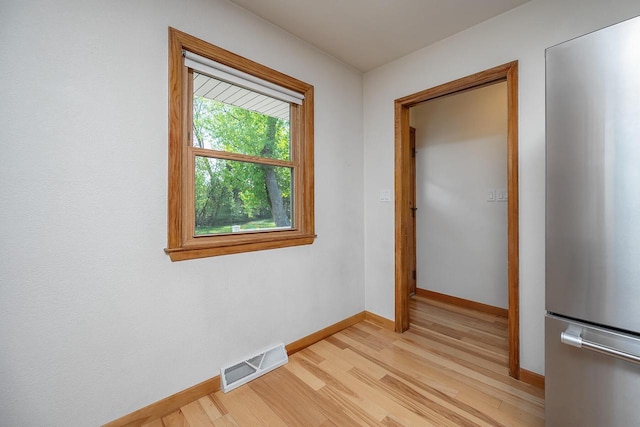 unfurnished room featuring light wood-style floors and baseboards
