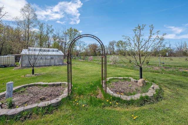 view of yard with a greenhouse and an outdoor structure