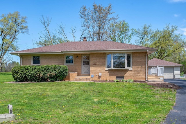 ranch-style house with brick siding, a front lawn, and a garage