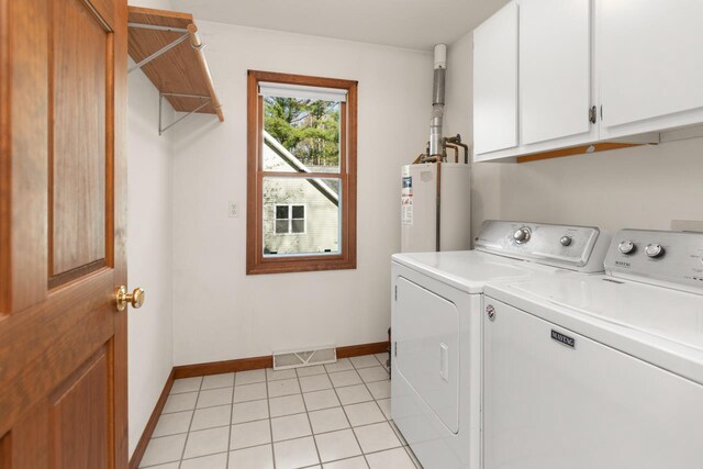 6615 Birchwood Shores Ln, Oconto Falls, WI 54154 - clothes washing area featuring water heater, separate washer and dryer, cabinet space, baseboards, and light tile patterned floors