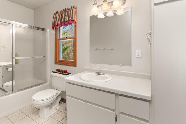 6615 Birchwood Shores Ln, Oconto Falls, WI 54154 - bathroom with toilet, tile patterned flooring, vanity, shower / bath combination with glass door, and a chandelier