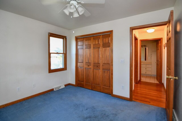 6615 Birchwood Shores Ln, Oconto Falls, WI 54154 - unfurnished bedroom featuring carpet, baseboards, a closet, and a ceiling fan