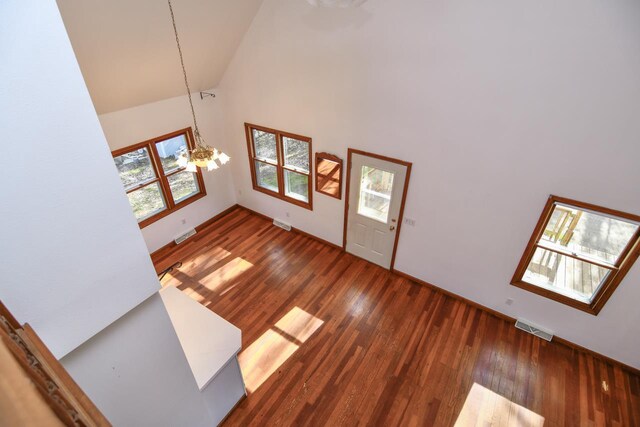 6615 Birchwood Shores Ln, Oconto Falls, WI 54154 - entrance foyer with a chandelier, high vaulted ceiling, wood finished floors, and baseboards
