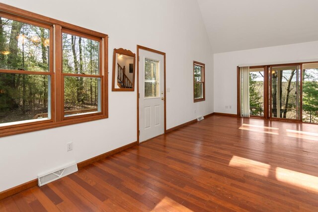 6615 Birchwood Shores Ln, Oconto Falls, WI 54154 - empty room with wood finished floors, baseboards, and high vaulted ceiling