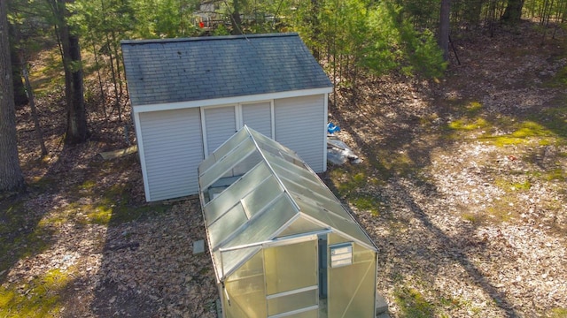 6615 Birchwood Shores Ln, Oconto Falls, WI 54154 - exterior view of a greenhouse and a shingled roof