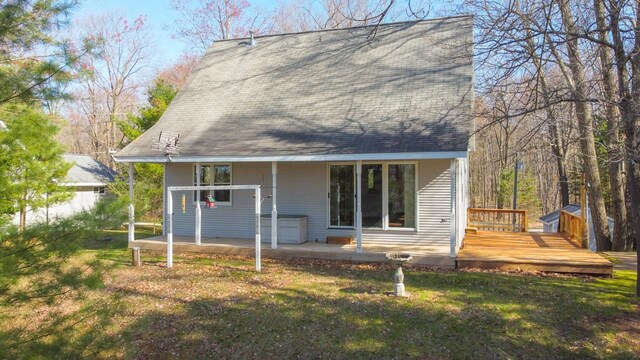6615 Birchwood Shores Ln, Oconto Falls, WI 54154 - back of house featuring a lawn, a deck, a shingled roof, and a patio area