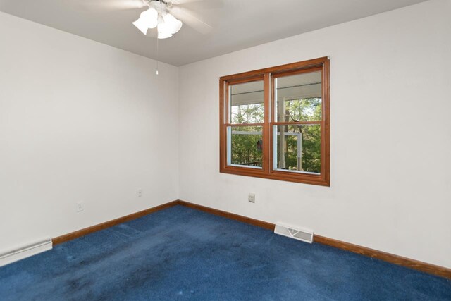 6615 Birchwood Shores Ln, Oconto Falls, WI 54154 - unfurnished room with baseboard heating, dark carpet, baseboards, and ceiling fan