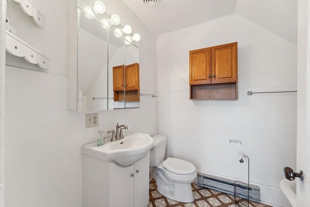 332 La Valle St, Reedsburg, WI 53959 - bathroom featuring a baseboard radiator, toilet, lofted ceiling, and vanity
