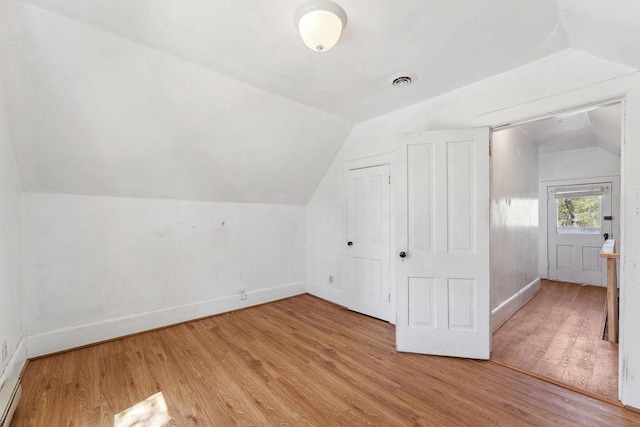 332 La Valle St, Reedsburg, WI 53959 - additional living space featuring lofted ceiling, baseboards, and wood finished floors