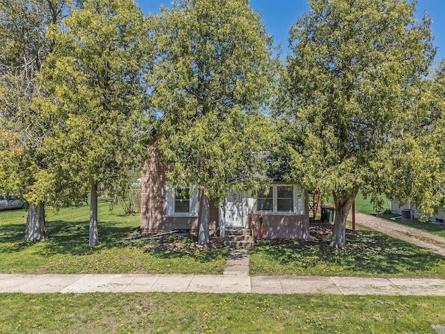 332 La Valle St, Reedsburg, WI 53959 - obstructed view of property featuring a front lawn and entry steps