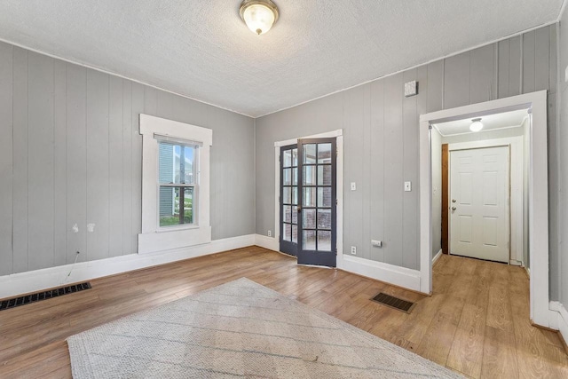 332 La Valle St, Reedsburg, WI 53959 - empty room with wood finished floors, baseboards, and a textured ceiling