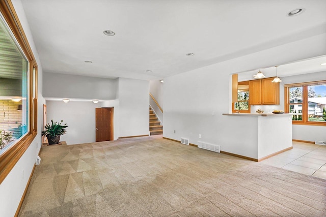 407 Edward St, Verona, WI 53593 - unfurnished living room with light carpet, stairway, recessed lighting, and baseboards