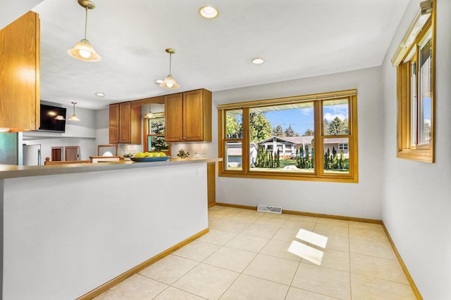 407 Edward St, Verona, WI 53593 - kitchen featuring brown cabinets, decorative light fixtures, baseboards, light tile patterned flooring, and recessed lighting