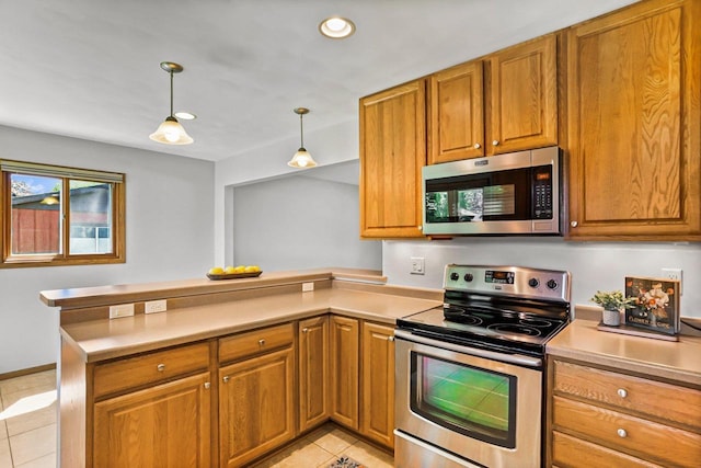 407 Edward St, Verona, WI 53593 - kitchen with appliances with stainless steel finishes, a peninsula, light tile patterned floors, brown cabinetry, and recessed lighting