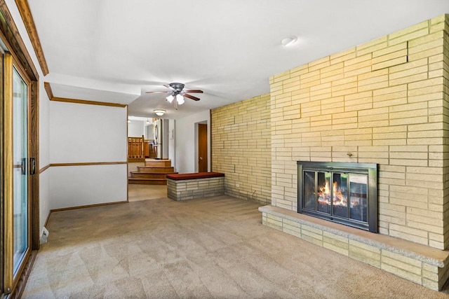 407 Edward St, Verona, WI 53593 - unfurnished living room with carpet flooring, a ceiling fan, a fireplace, stairway, and baseboards