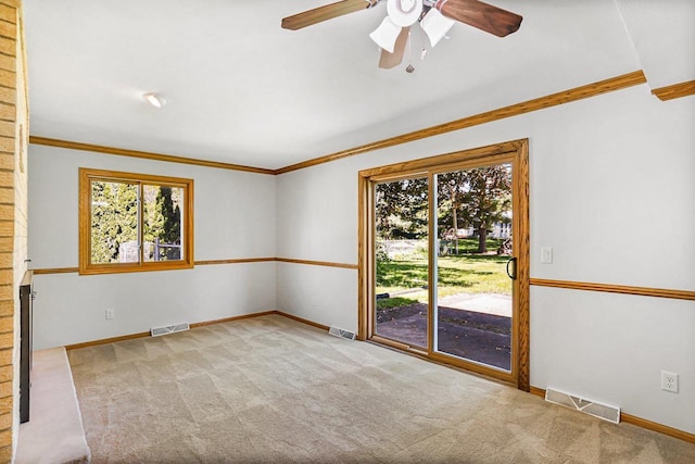 407 Edward St, Verona, WI 53593 - carpeted empty room with plenty of natural light, crown molding, a ceiling fan, and baseboards