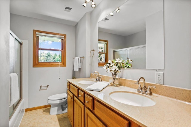 407 Edward St, Verona, WI 53593 - full bath with toilet, double vanity, bath / shower combo with glass door, baseboards, and tile patterned flooring