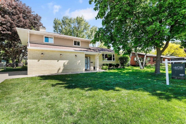 407 Edward St, Verona, WI 53593 - rear view of house featuring brick siding and a chimney