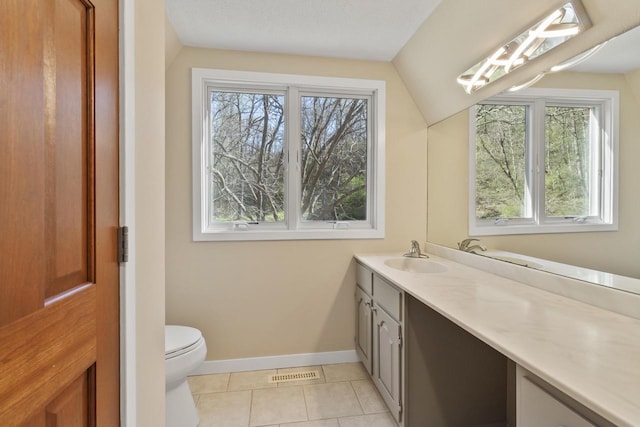 W5685 Koss Rd, Onalaska, WI 54650 - bathroom with vanity, baseboards, tile patterned flooring, lofted ceiling, and toilet