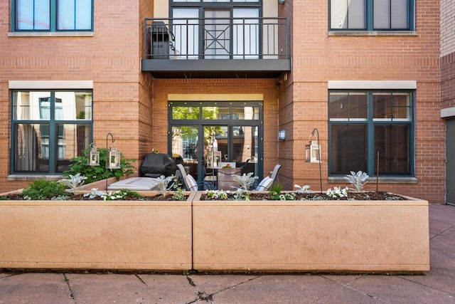 530 W Doty St Unit 105, Madison, WI 53703 - doorway to property featuring a balcony and brick siding