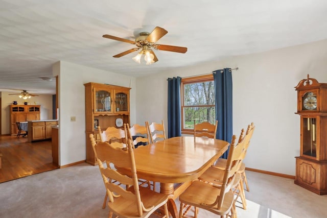 7938 E Hwy 59, Milton, WI 53563 - dining area featuring a ceiling fan, light carpet, and baseboards