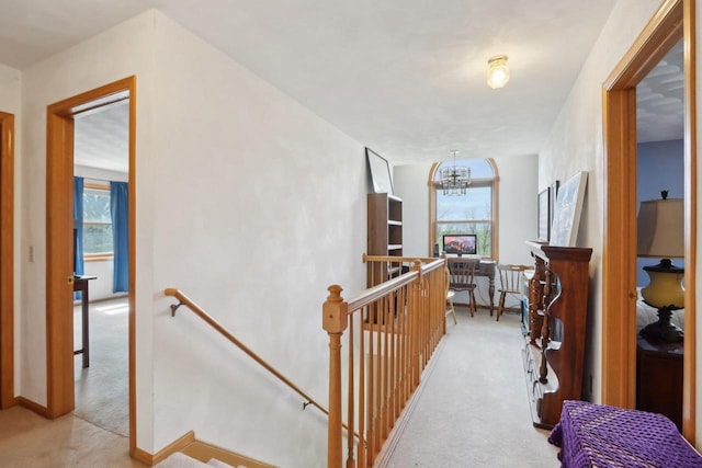 7938 E Hwy 59, Milton, WI 53563 - hallway featuring an upstairs landing, light carpet, and a chandelier