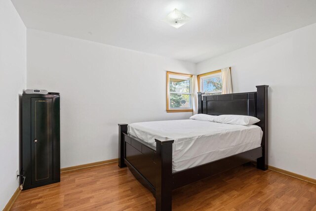 9517 W Capitol Dr, Milwaukee, WI 53222 - bedroom with light wood-style floors and baseboards
