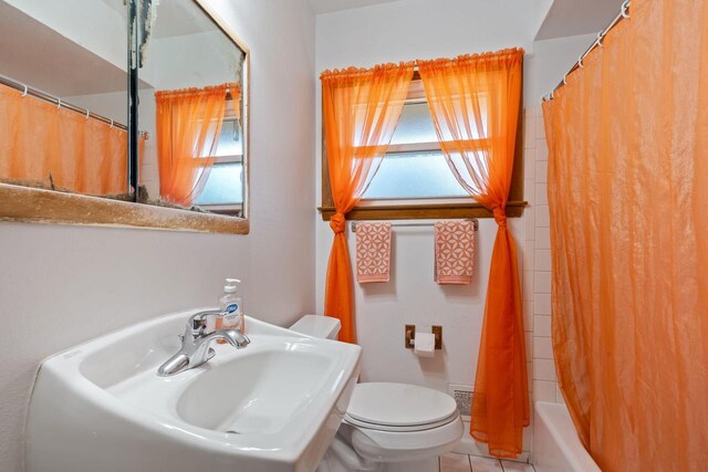 9517 W Capitol Dr, Milwaukee, WI 53222 - bathroom featuring plenty of natural light, toilet, tile patterned flooring, and a sink