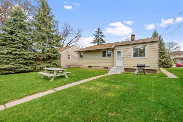 9517 W Capitol Dr, Milwaukee, WI 53222 - rear view of property with a chimney and a lawn