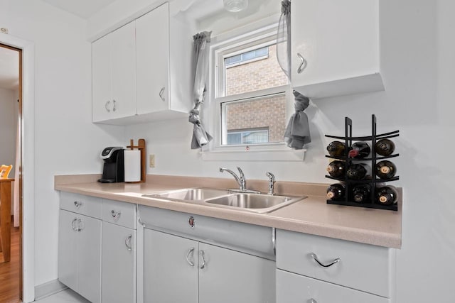 9517 W Capitol Dr, Milwaukee, WI 53222 - kitchen with a sink, white cabinetry, and light countertops