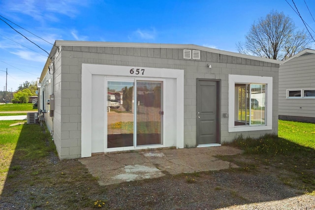 657 Elm St, Black River Falls, WI 54615 - back of property featuring concrete block siding and cooling unit